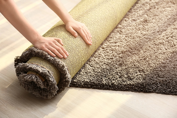 woman rolling carpet